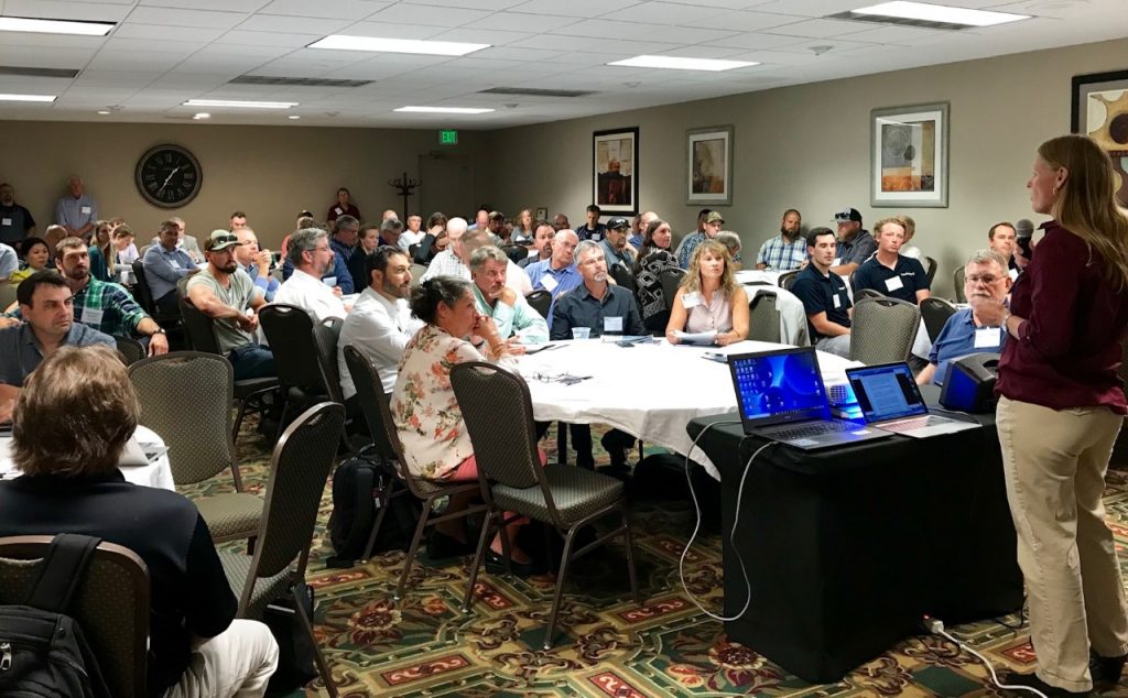 Newly elected USTFA president Katie Harris welcomes delegates to the United States Trout Farmers Association Fall Conference in Seattle, WA. (Credit: Liza Mayer)