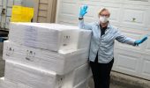 Debbie Miller, Manager of the Campbell River Foodbank, safely receives a pallet of salmon fillets donated by Mowi Canada West. (Credit: B.C. Salmon Farmers Association)